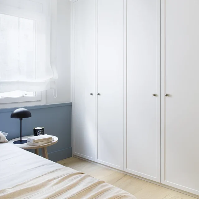 Armarios blancos y mesita de noche en dormitorio - Proyecto Balmes