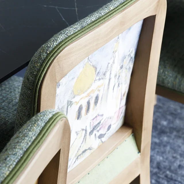 Parte trasera de sillas de comedor con pinturas y dibujos.