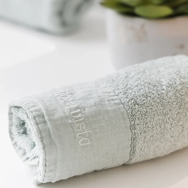 Toalla verde pastel enrollada.